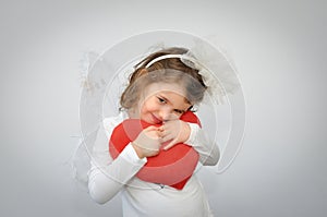 Young girl holding a plush red heart